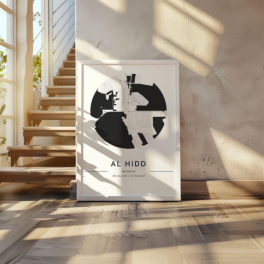 The Al Hidd City Map by FN Prints rests on a wooden floor near a staircase in a sunlit, modern interior—ideal Bahrain wall art for any contemporary space.