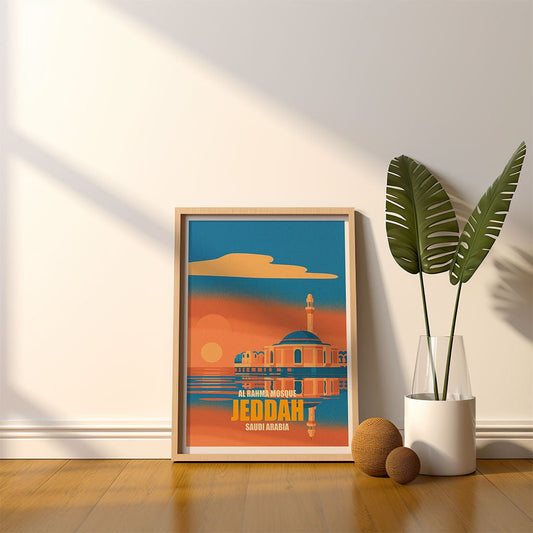 Framed poster of Jeddah with a plant and decorative items on a wooden floor.