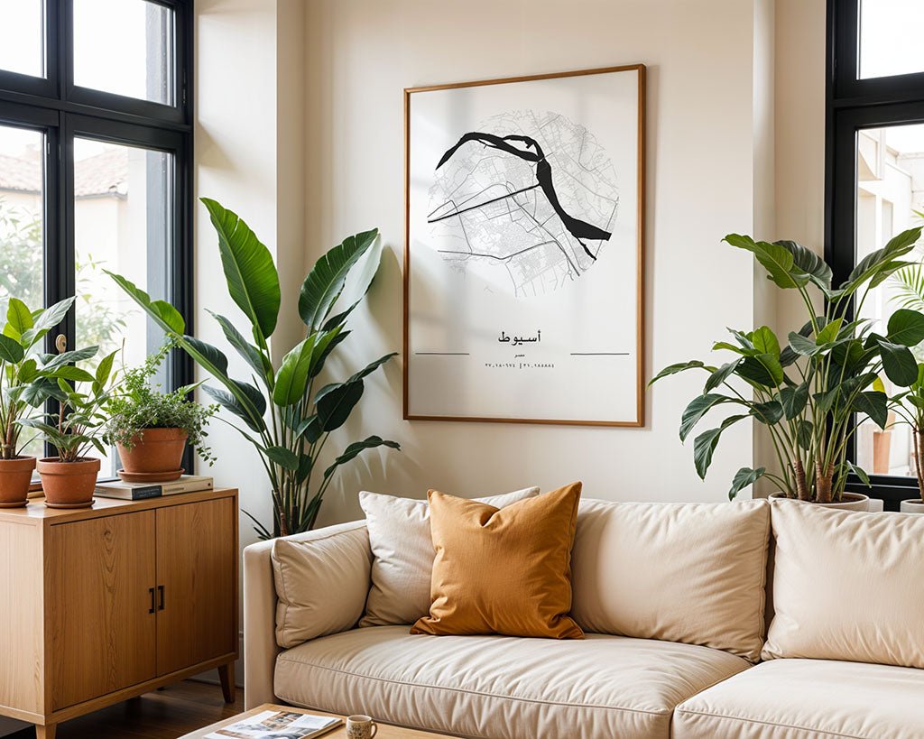 A cozy living room boasts a beige couch with a brown pillow amid green potted plants. The FN Prints Assiut City Map, printed on museum-quality fine art paper, adds sophistication to the wall, while large windows flood the space with natural light.