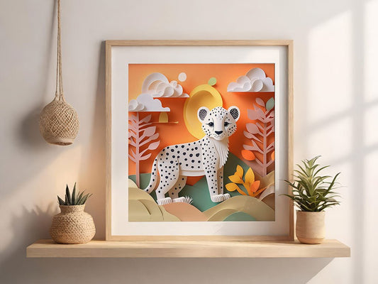 The framed digital artwork titled *Cameron The Cheetah Cub* from FN Prints showcases a stylized illustration of a cheetah with its cub amid a vibrant savanna landscape, rich with orange hues, clouds, and trees. It is elegantly displayed on a wooden shelf accompanied by two potted plants and a woven hanging basket.