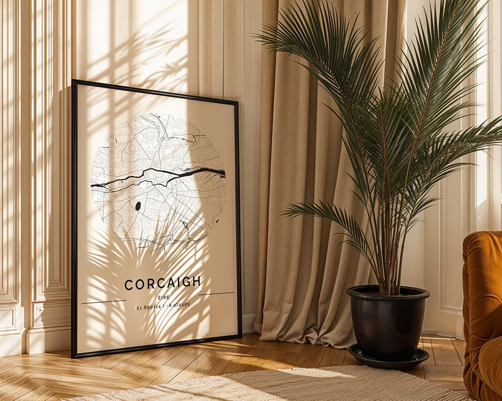 In a sunlit room, the FN Prints Cork City Map leans against a wall, accompanied by a thriving potted palm casting shadows on wooden floors. Beige curtains and an upholstered chair enhance the warmth of this eco-friendly art space.