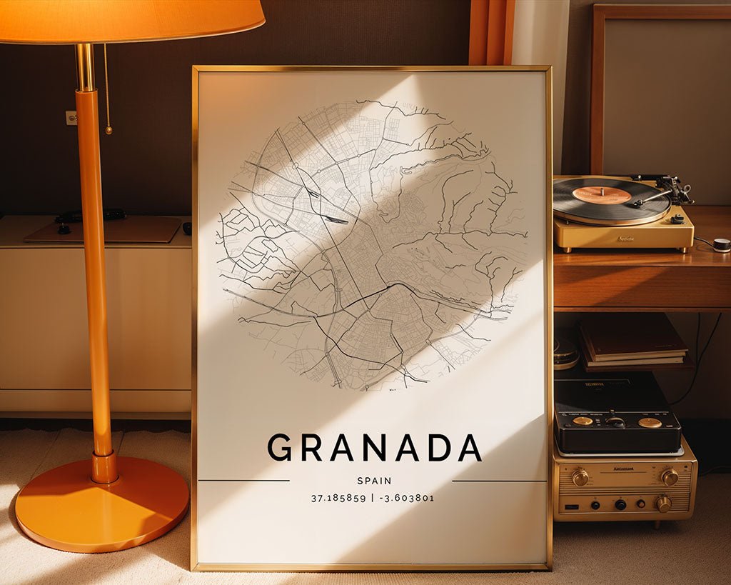 A FN Prints Granada City Map leans against the wall, bathed in sunlight and displaying coordinates. A vintage turntable and radio enhance the Scandinavian style, while an orange lamp adds a vibrant touch to this elegant minimalist print scene.