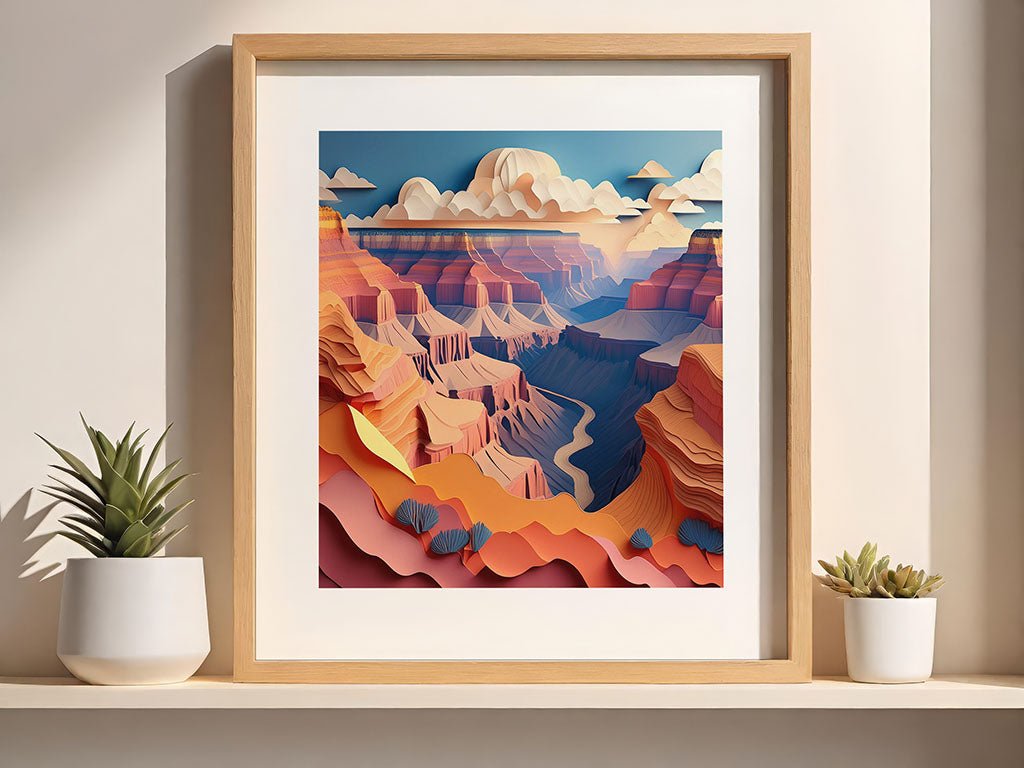 A framed digital artwork by FN Prints, titled "Grand Canyon," showcases a paper-effect design of a stylized, colorful landscape reminiscent of the Grand Canyon. The scene depicts layered rock formations beneath a blue sky adorned with clouds. Two small potted succulents are positioned on the shelf next to the frame.
