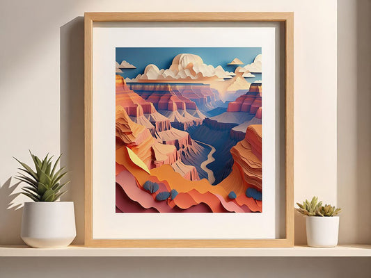 A framed digital artwork by FN Prints, titled "Grand Canyon," showcases a paper-effect design of a stylized, colorful landscape reminiscent of the Grand Canyon. The scene depicts layered rock formations beneath a blue sky adorned with clouds. Two small potted succulents are positioned on the shelf next to the frame.