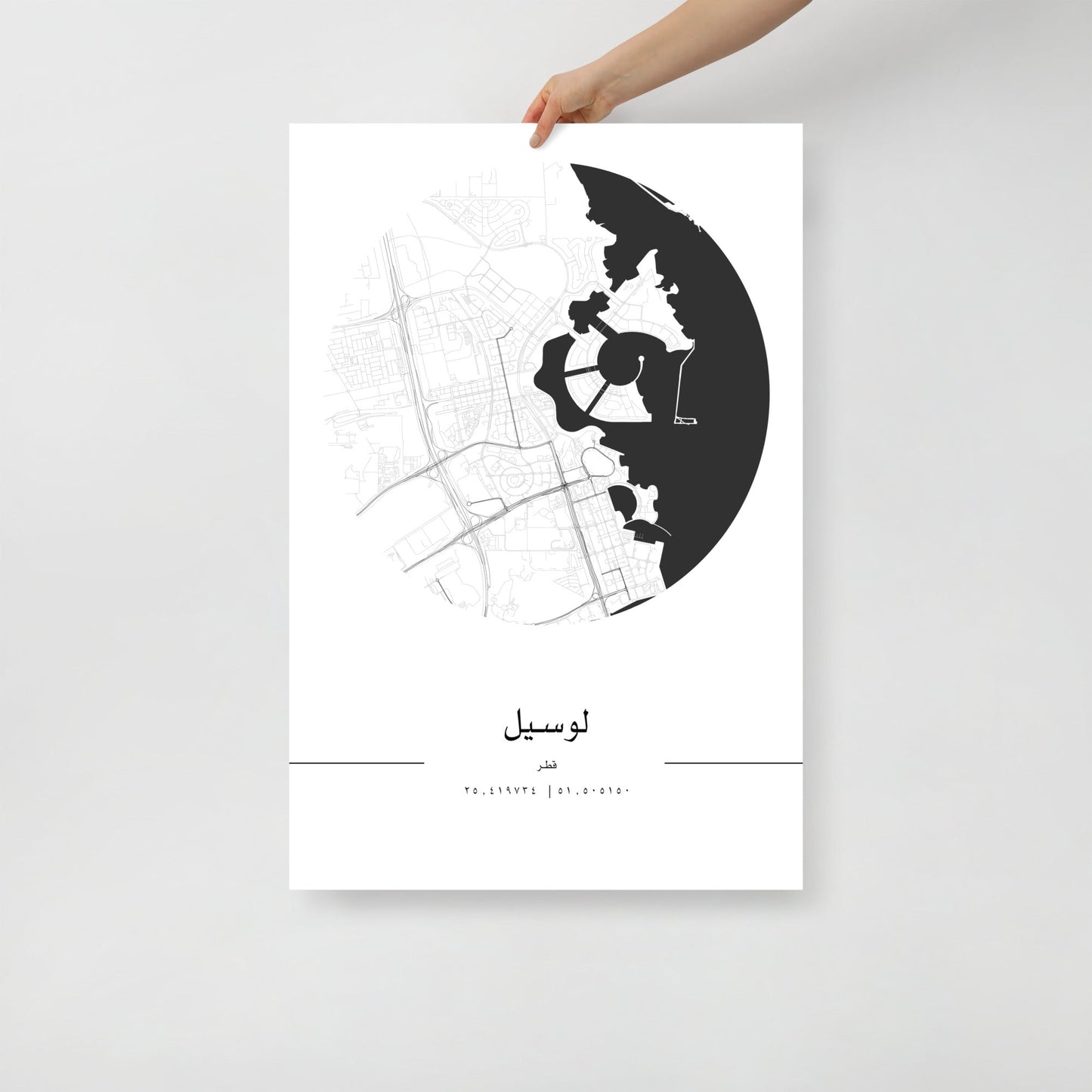 A black and white minimalist map poster of Lusail City, Qatar, held by a hand against a white background.