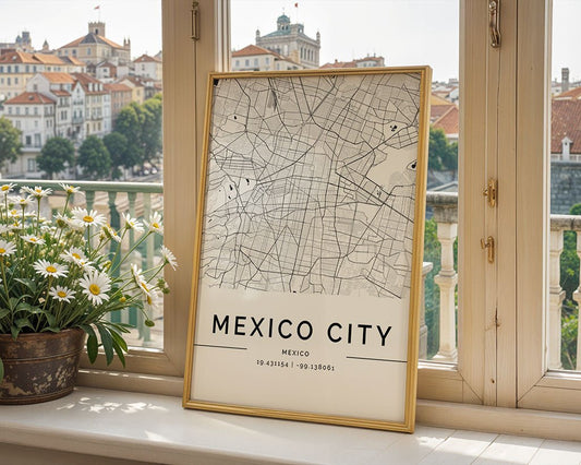 A framed FN Prints Mexico City Map rests against a window, featuring intricate street layouts on museum-quality fine art paper. Red-roofed buildings and trees form an urban tapestry in the background, while a pot of daisies adds nature to this minimalist print.
