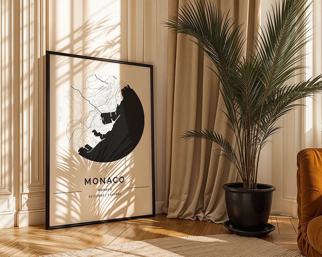 An FN Prints Monaco City Map, showcasing minimalist art on museum-quality paper, rests against a wall with drapes. A large potted plant stands on the wooden floor, catching sunlight, while a brown sofa peaks into this tranquil scene.