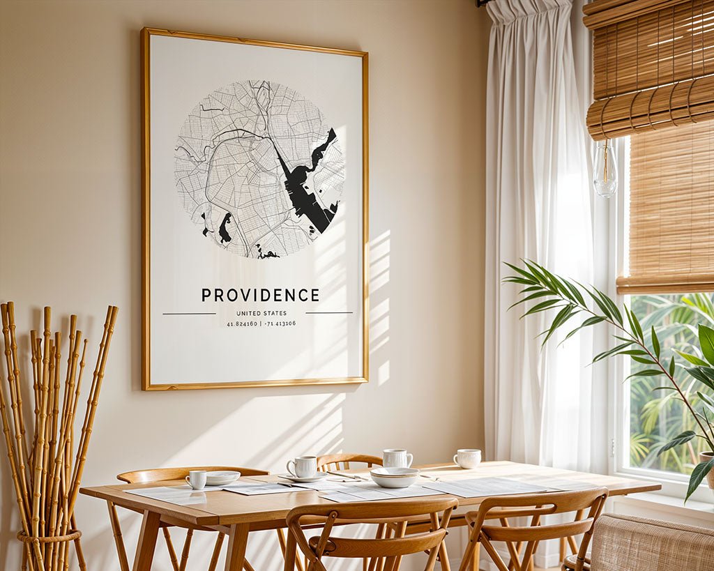 In a minimalist dining space, sunlight filters through curtains onto a wooden table and chairs set for tea. A FN Prints Providence City Map adorns the wall, adding charm, while a potted plant and bamboo sticks enhance the corner.