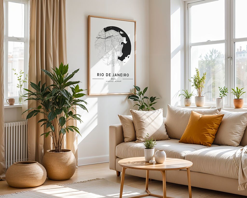 A bright living room features a beige sofa with mustard and white cushions, a light wood table, and potted plants. The FN Prints Rio de Janeiro City Map adds urban flair to the wall. Large windows fill the space with natural light.