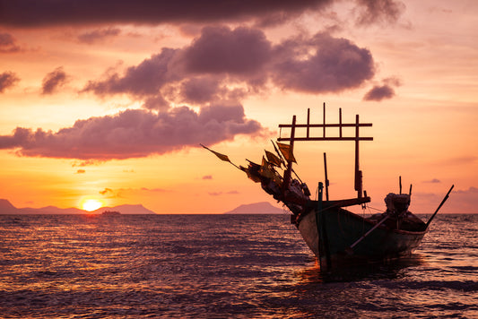 Sunset at Sea with a small local fishing Boat