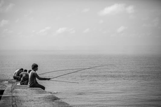 Kid casting their fishing rods of a jetty in Thailand