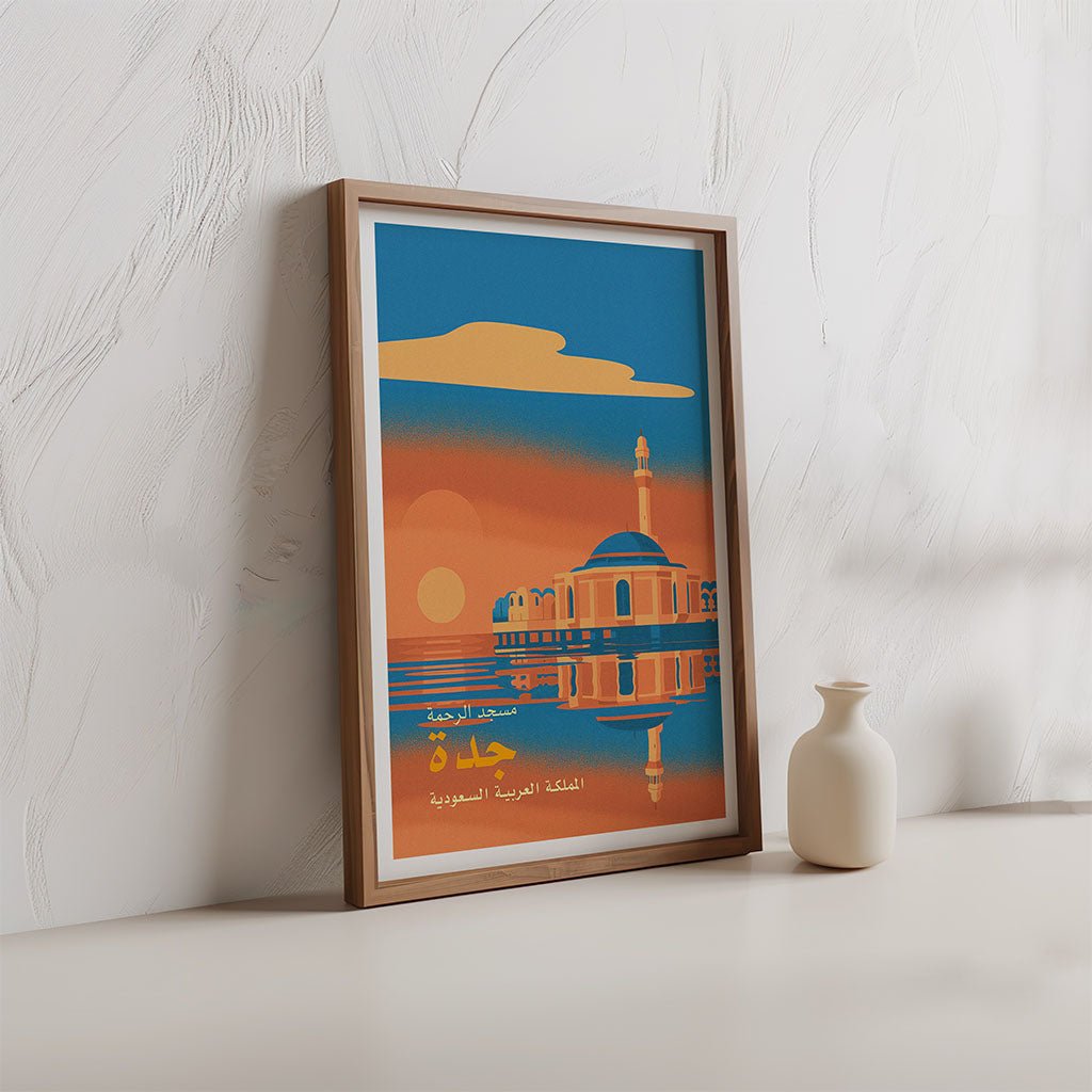 Framed poster of Jeddah with a plant and decorative items on a wooden floor.