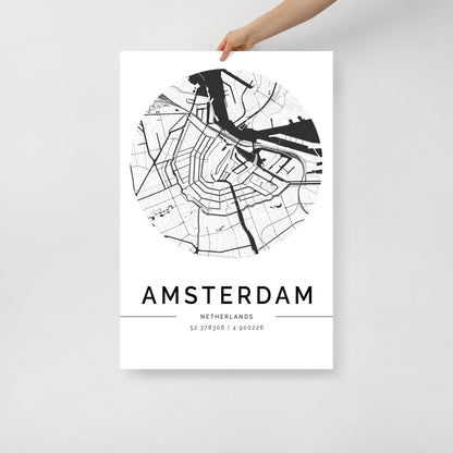 A hand holds a sleek Amsterdam Map from FN Prints, ideal for urban design wall art. This minimalist black and white poster beautifully showcases the city's streets and canals, with "AMSTERDAM" and its geographic coordinates elegantly printed below.