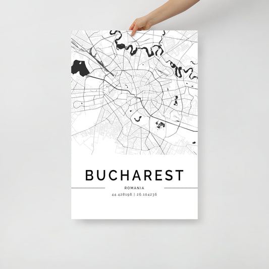 A person holds a minimalist black and white Bucharest City Map poster by FN Prints, offering a glimpse into Romanian culture. This map showcases streets and waterways, with geographic coordinates 44.4268° N, 26.1042° E elegantly displayed at the bottom, making it an ideal wall art print.