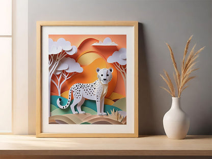 FN Prints presents "Caspian The Cheetah Cub," a framed digital art piece showcasing a paper-cut style illustration of a cheetah cub in a stylized landscape with trees and a setting sun. Perfect for children's decor, this artwork is displayed on a shelf beside a white vase with dried grass stems.