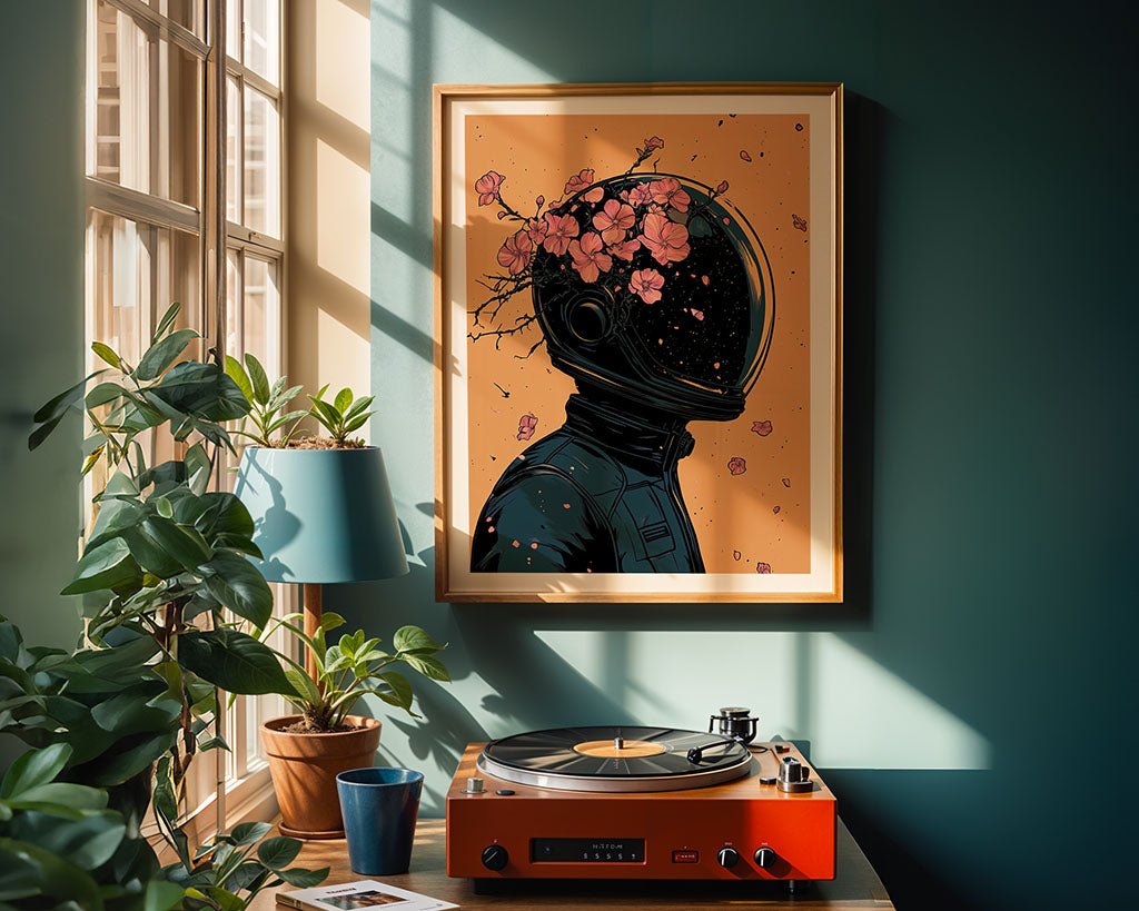 In a sunlit room, a record player rests on a teal cabinet beside a lamp and potted plant. Above, the wall features FN Prints' "Cosmic Bloom – Dark Astronaut Digital Art Print," showcasing an astronaut with pink flowers. The matching teal wall enhances the space theme.