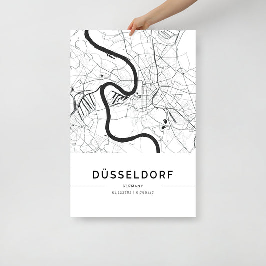 A hand holds the striking FN Prints Düsseldorf City Map Wall Art Print in black and white, with elegantly printed geographic coordinates below, adding a touch of sophistication.