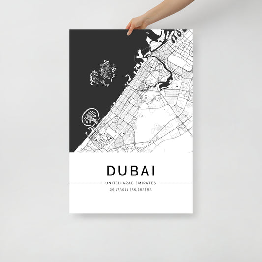 A person is holding a FN Prints Dubai Map, a poster printed on premium-quality paper. This contemporary wall art showcases a monochrome layout of the city's streets and landmarks, including the Palm Jumeirah, and elegantly features Dubai's coordinates at the bottom.