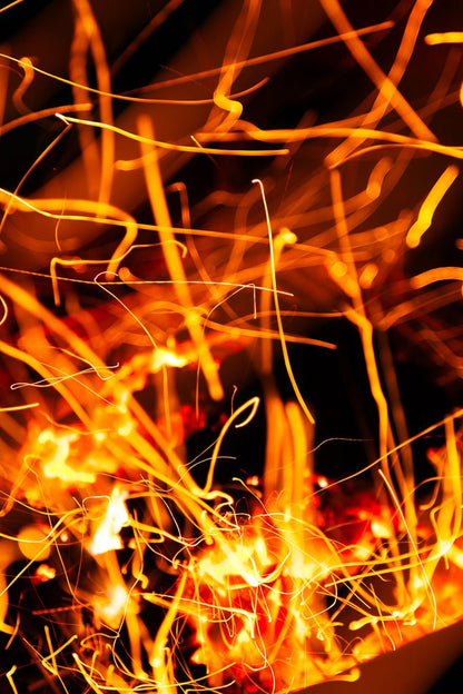 Firebrands by FN Prints features a vibrant display of orange and yellow light trails against a dark background, resembling abstract patterns created by fire photography. The intertwining lines and bursts of light create a dynamic and energetic visual effect, perfect for abstract wall art.