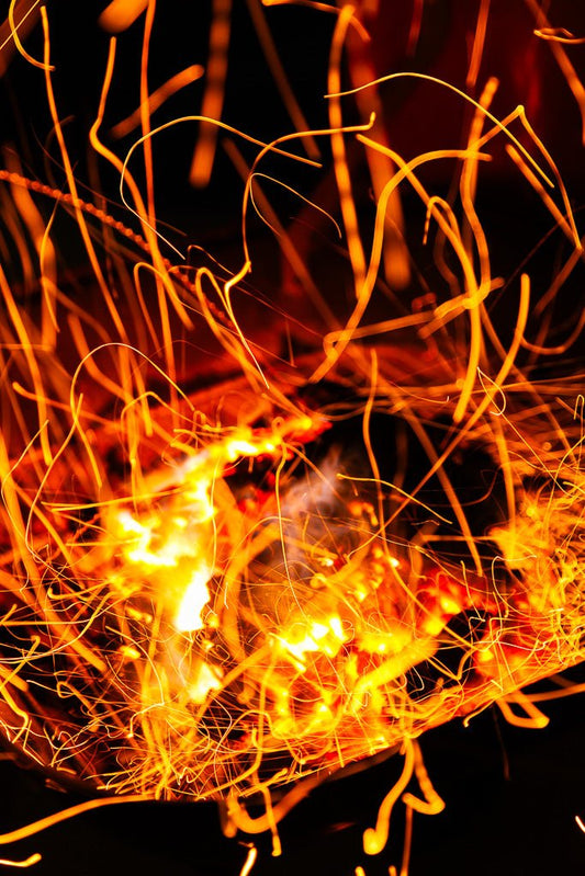 The Firebrands III by FN Prints features an abstract image of dancing, intertwined orange and yellow lines created by long-exposure fire photography against a dark background. The glowing streaks resemble energetic, swirling trails of light, creating a dynamic and vibrant visual effect perfect for abstract wall art.