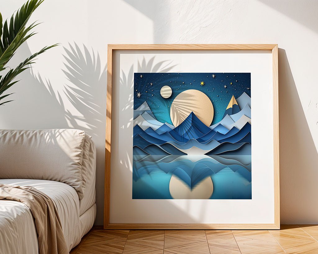 FN Prints' "Full Moons" showcases abstract digital art with layered blue mountains and a large moon casting reflections on water, all set under a starry night sky. The mystical ambiance is enhanced by the frame leaning against the wall, as plant shadows cast a serene charm on nearby surfaces.