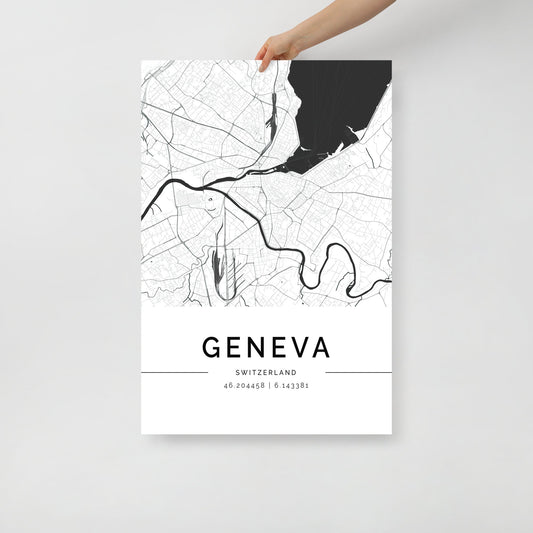 A hand holds a sleek black and white FN Prints Geneva City Map, showcasing roads, rivers, and intricate geographic details. Ideal for wall art, the text at the bottom reads "Geneva, Switzerland" with precise coordinates 46.204558 | 6.143381.