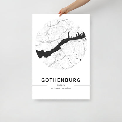 A person holds a black and white FN Prints Gothenburg City Map poster, an exquisite example of Scandinavian design. This wall art print beautifully displays the city's complex layout, featuring precise coordinates at the bottom: 57.709492° N, 11.958504° E.