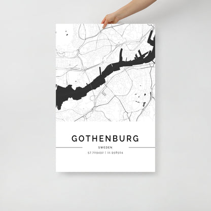 A person holds the exquisite Gothenburg City Map by FN Prints, a striking wall art piece that features a minimalist Scandinavian design with intricate black and white details. The artwork elegantly highlights the city's coordinates: 57.709492° N, 11.958804° E.