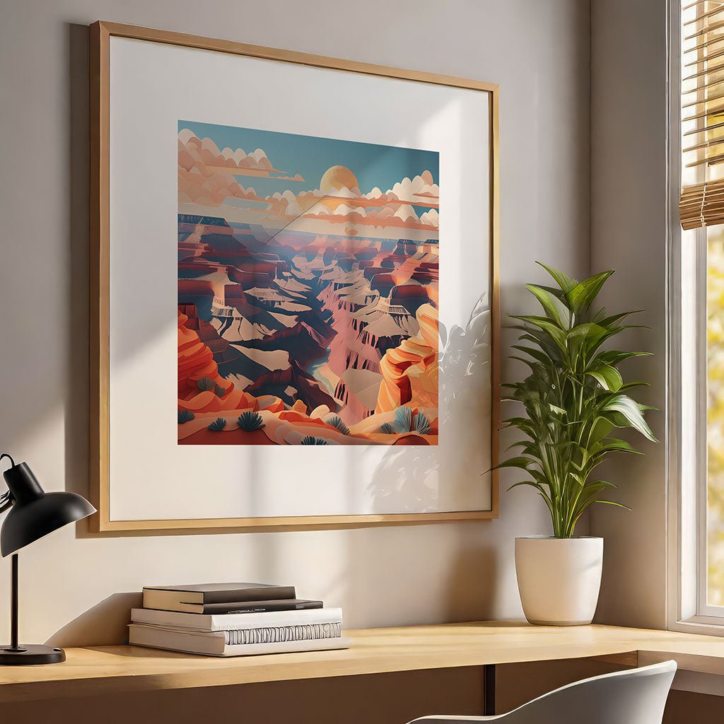 A framed digital artwork titled "Grand Canyon III" by FN Prints, showcasing a colorful landscape with a folded paper effect, is mounted on the wall above a wooden desk. The desk holds a small plant in a white pot, alongside a lamp and some books. Sunlight filters through the window, casting soft shadows.