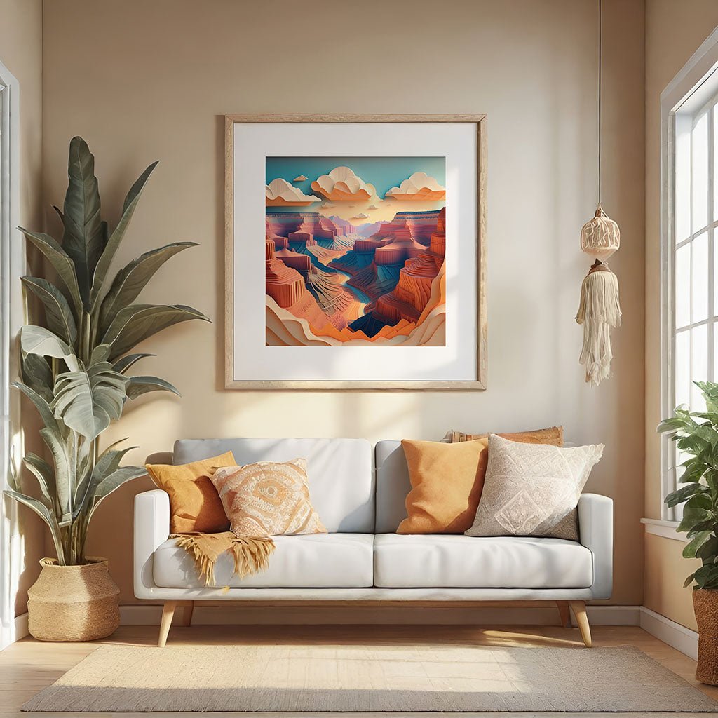 The cozy living room features a white sofa decorated with orange and white pillows, complemented by a large plant on the left. Above the sofa is "Grand Canyon IV," a framed abstract landscape print from FN Prints, exhibiting warm tones and creating an effect reminiscent of folded paper inspired by the Grand Canyon. Light streams in through large windows.