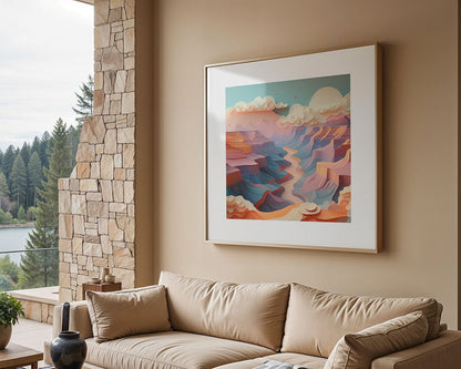 A cozy living room with a beige sofa and cushions is shown. A framed digital abstract landscape artwork titled "Grand Canyon VI" by FN Prints, featuring a pastel palette, hangs on the wall. The room includes stone accents and large windows that offer a tranquil view of trees and a lake outside.