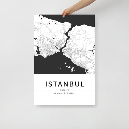 An individual displays a captivating FN Prints Istanbul City Map poster, ideal for wall art enthusiasts. This piece showcases an urban design with a black and white map, featuring geographical coordinates at the bottom: 41.00419 | 28.978931.