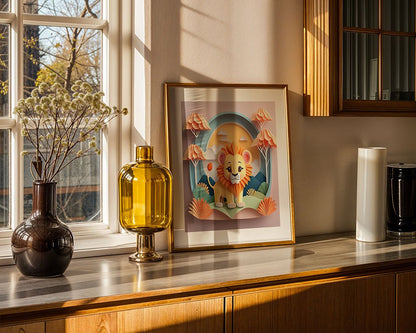 In a sunlit room, a countertop features "Lake The Lion Cub," a framed digital art print from FN Prints depicting an illustration of a lion among abstract landscapes. Next to it, a brown vase with delicate branches complements a yellow glass vase. Gentle shadows cast by outdoor trees visible through the window spark imaginative play in children's spaces.