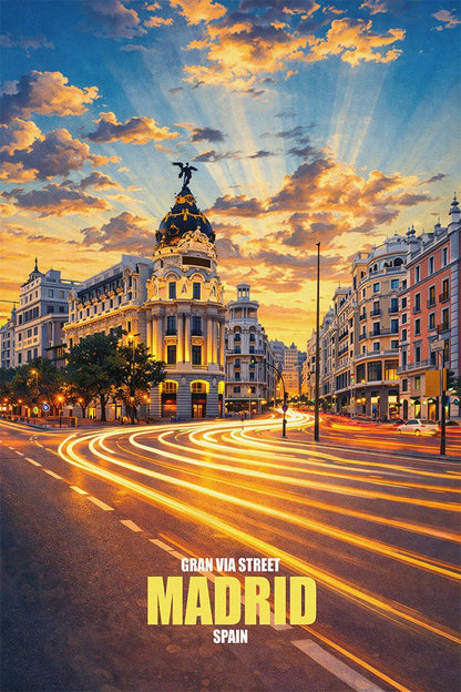 Digital art poster of Gran Via Street in Madrid, Spain, at sunset, featuring light trails from cars, the historic Metropolis Building, and golden sunlight rays through clouds.