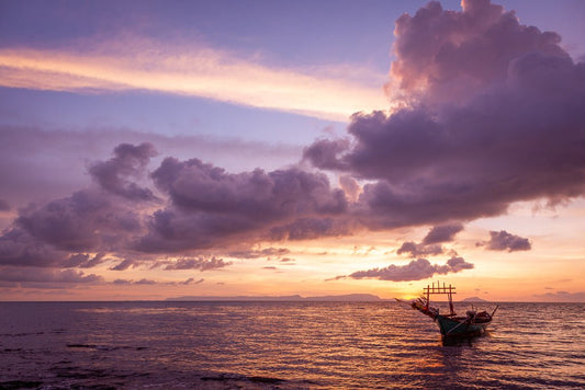 Sunset at Sea with a small local fishing Boat