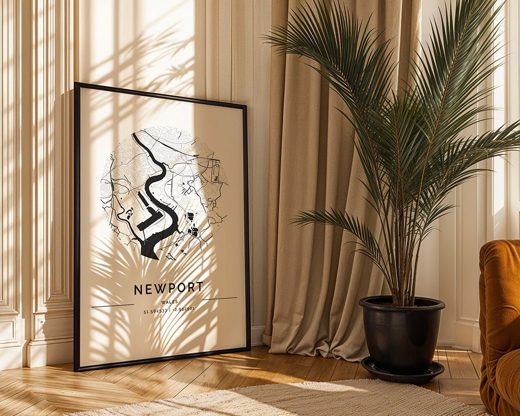 The FN Prints framed "Newport City Map" leans against a white wall, complemented by sunlight-bathed potted plants and beige curtains. The wooden floor and streaming light underscore the minimalist print's earthy charm.