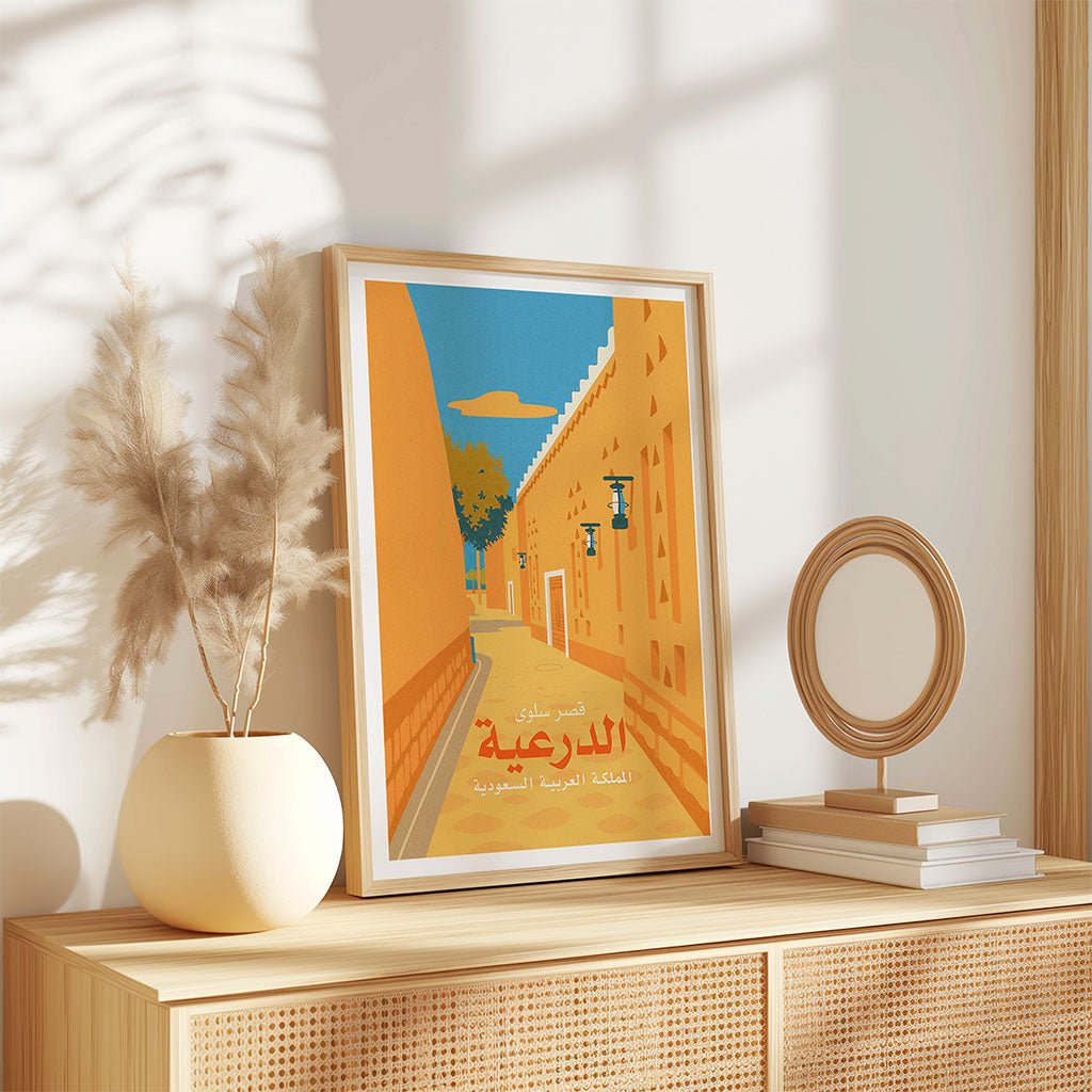 Framed artwork on a wooden shelf with decorative items