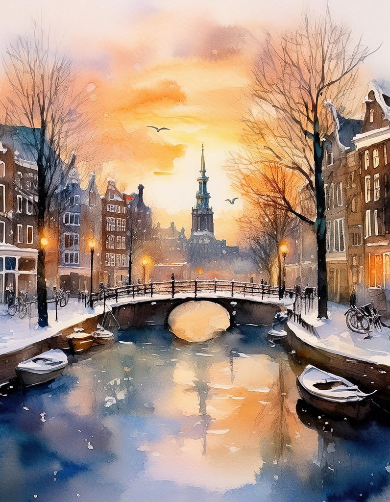 The "Winter In Amsterdam" print by FN Prints captures a picturesque winter scene featuring a canal bordered by snow-covered buildings and trees, set against a vibrant sunset sky. A stone bridge crosses the canal in the foreground, while a tall church steeple rises in the distance. Boats and bicycles line the canal's edge, perfectly encapsulating wintertime charm in Amsterdam.